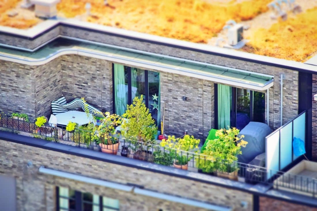 Bovenaanzicht van een dakterras met planten en tuinmeubelen